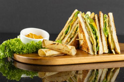 A Club Sandwich in a wood tray.