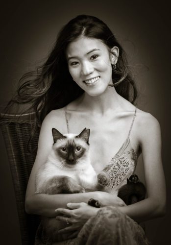 Rebeca with her cat sitting on her lap